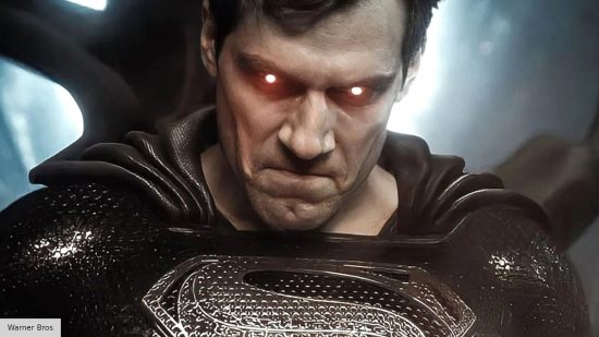 Henry Cavill wearing the black Superman suit, about to ese his eye lasers in Zack Snyder's Justice League